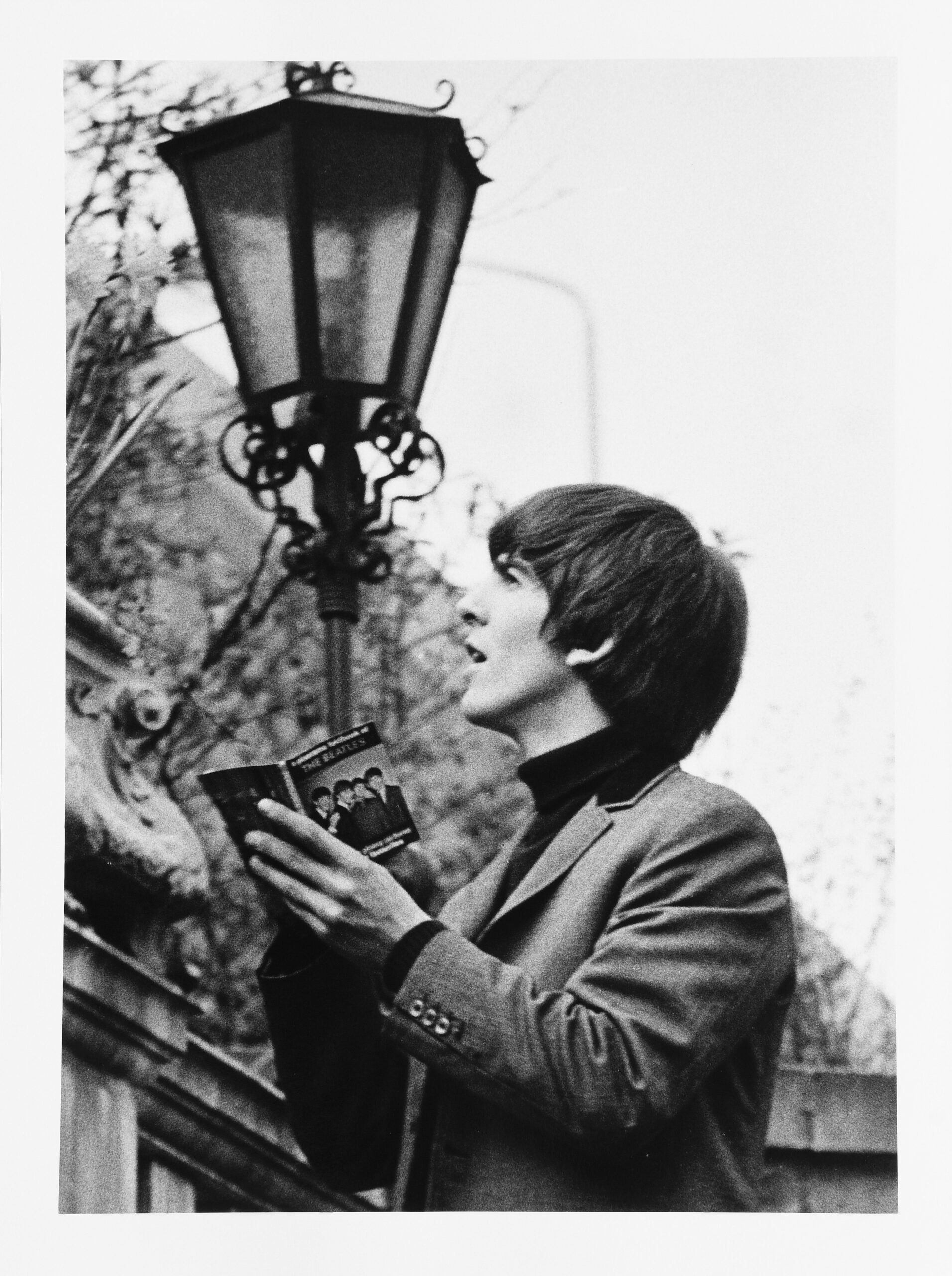 George Harrison signing a book in the walled garden of the Ambassadeurs Club, Mayfair by Lord Cristopher Thynne