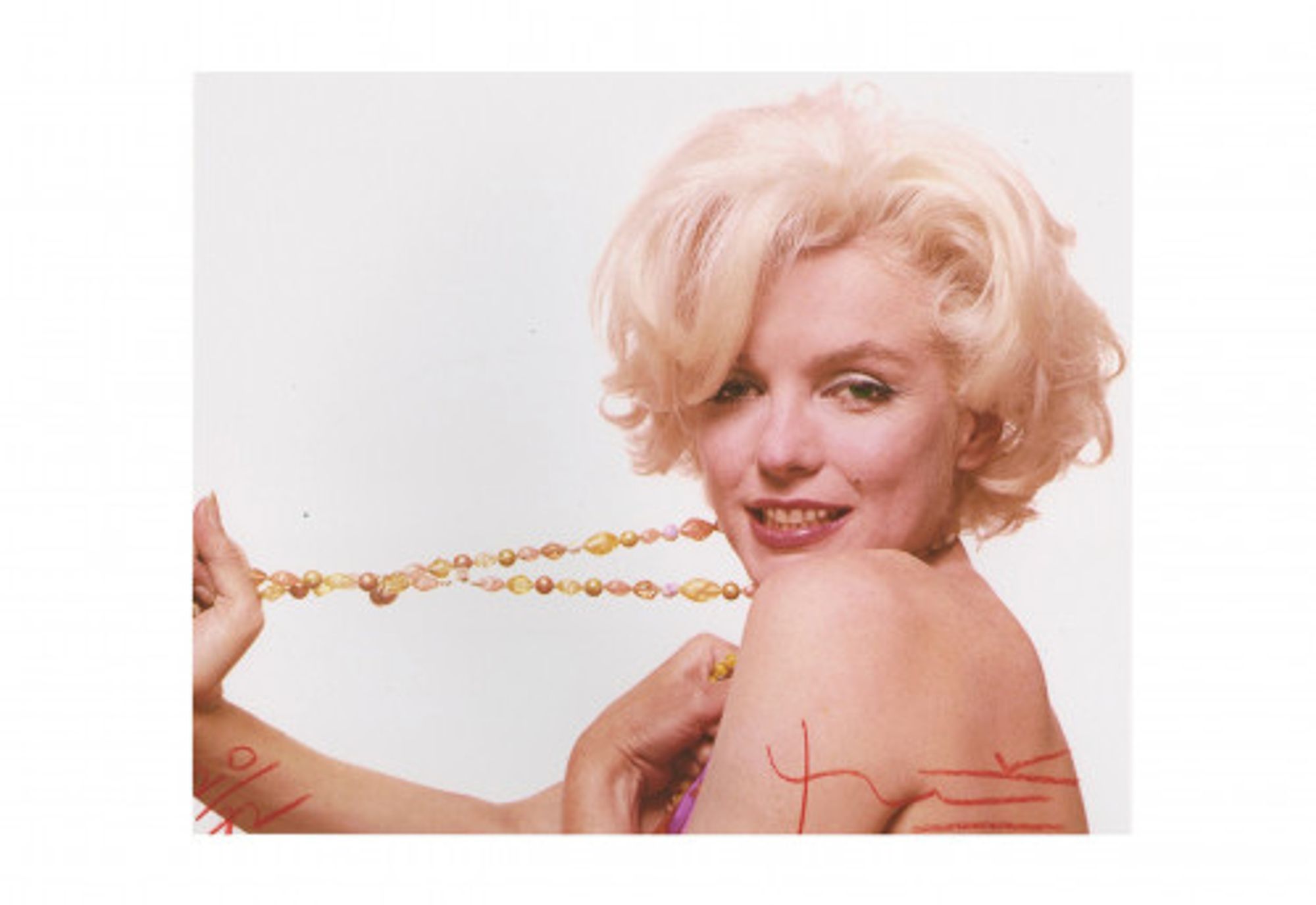 Marilyn stretching the jewelry by Bert Stern