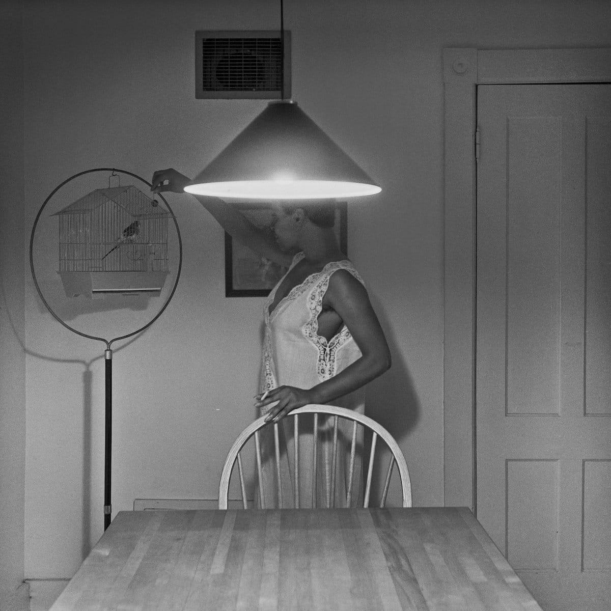 Untitled (Woman Feeding Bird), The Kitchen Table Series, 1990 by Carrie Mae Weems