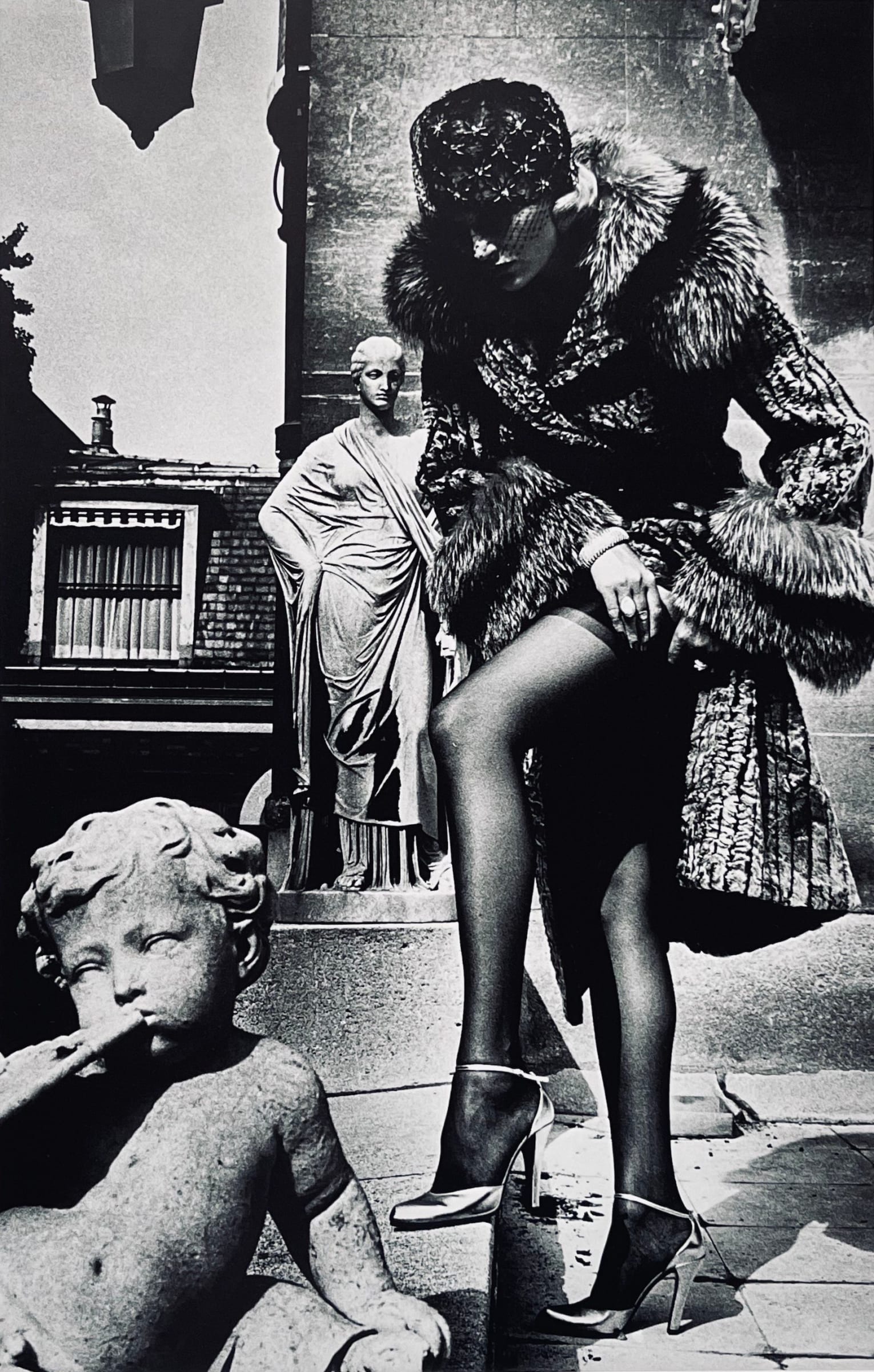 Woman in Coat Adjusting Stocking, Paris 1975 by Helmut Newton